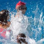 Two kids jump into the deep end at once