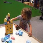 Mina building a house for her doll