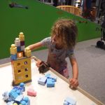 Mina building a house for her doll